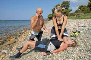 couple giving cpr to woman on beach