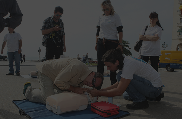 Shaded Citizen Providing CPR, First Aid On Beach