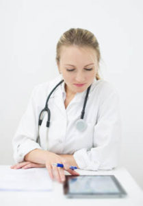 female nurse using ipad