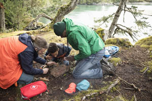 men-teaching-a-boy-how-to-make-a-fire