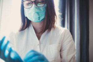 medical-nurse-with-facial-mask-and-gloves