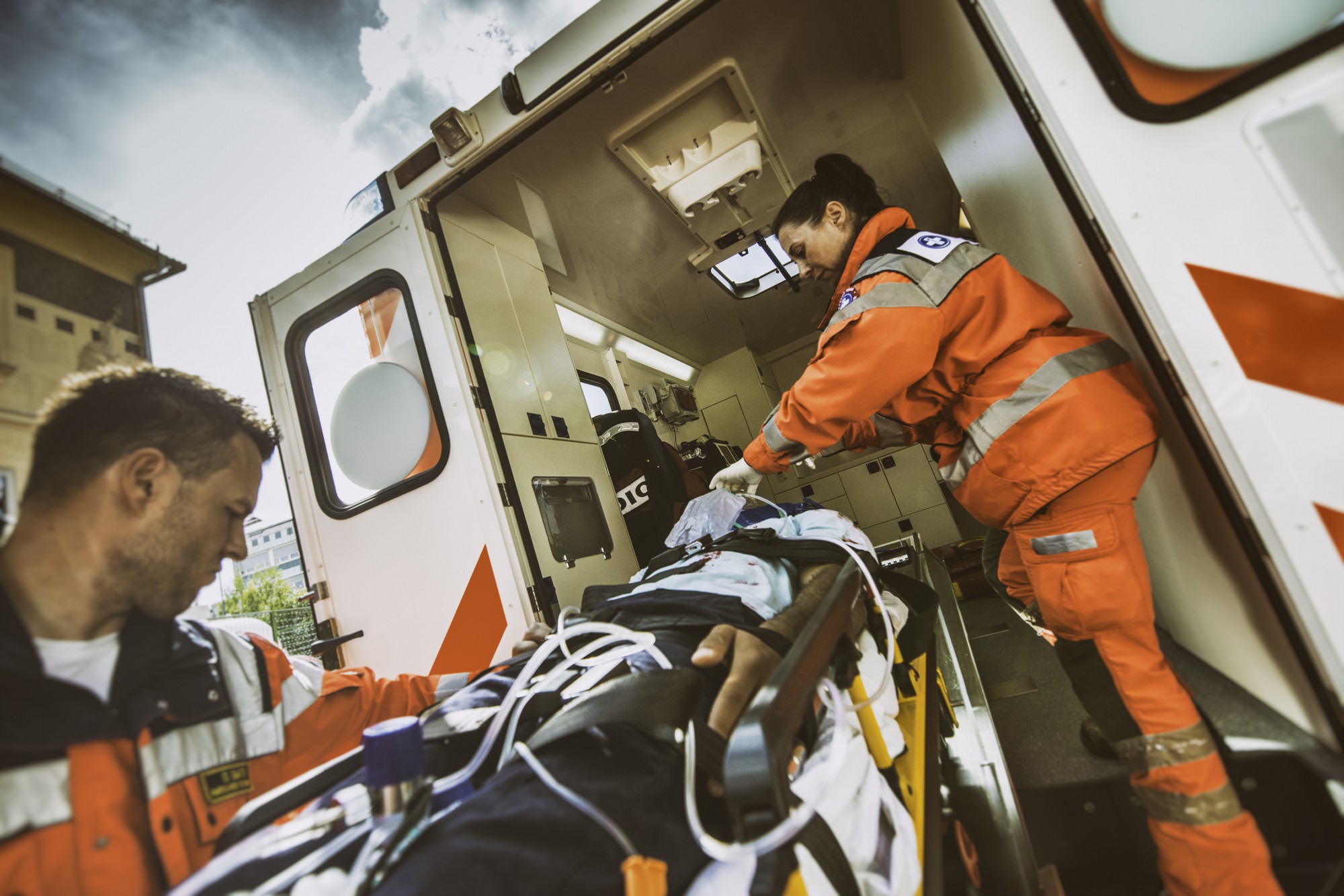 Paramedic moving the patient to the ambulance