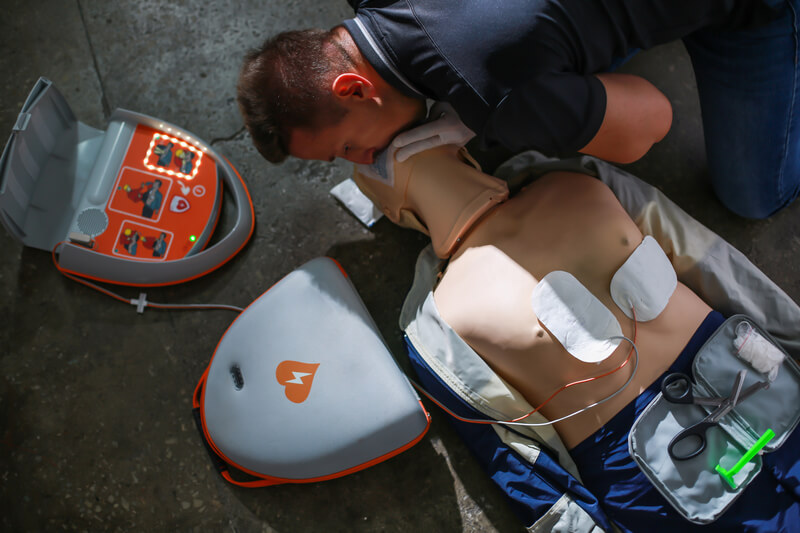 Medical student performing mouth to mouth resuscitation on a mannequin