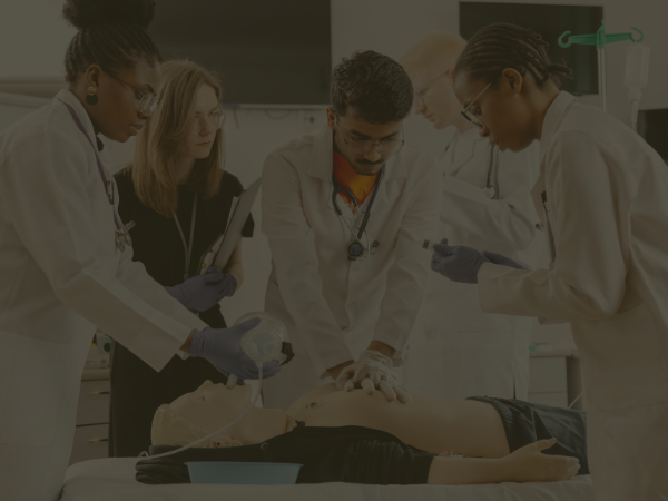 medical student performing compressions on a mannequin f